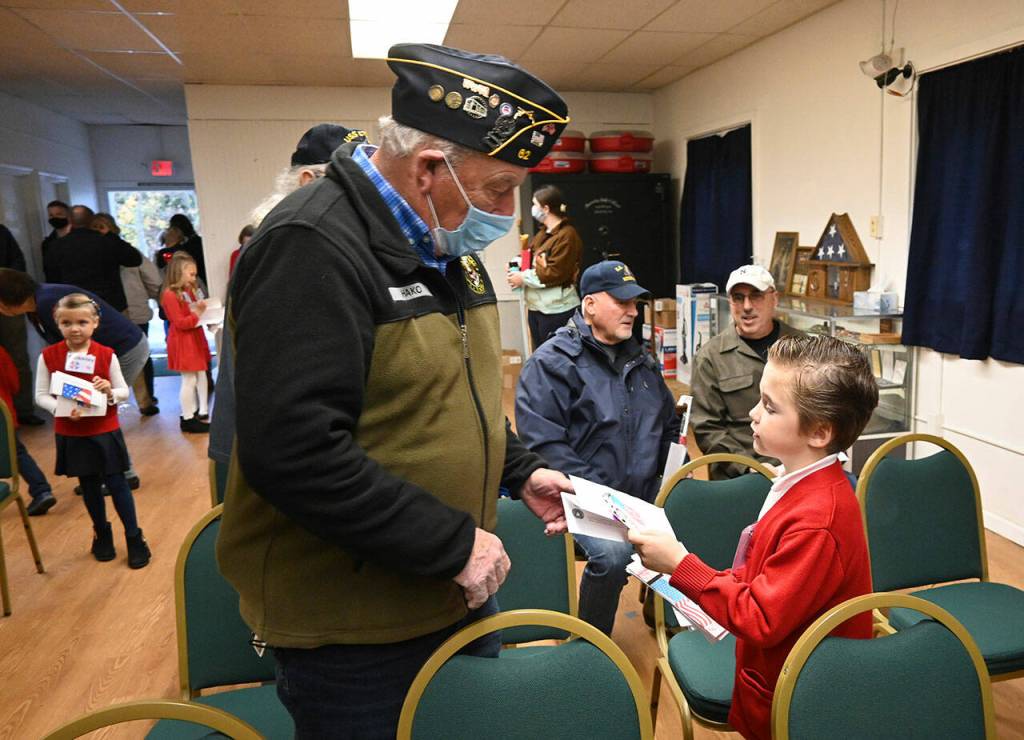Samuel Jones, 7, of Port Angeles, greets Sequim veteran Ed Hako at the American Legion Jack Grennan Post No. 62. (Michael Dashiell/Olympic Peninsula News Group)