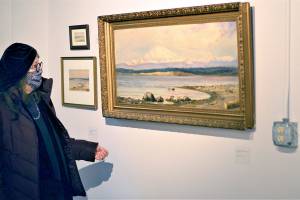 Jenny Westdal, Jefferson County Historical Society board president, admires one of Adeline Willoughby McCormacks paintings in the Women Outdoors show at the Jefferson Museum of Art & History. (Diane Urbani de la Paz/Peninsula Daily News)