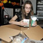 River Jensen, 15, sorts one of the many boxes of toiletries she plans to distribute to local agencies prior to Christmas. She's donated thousands of bags to in-need individuals across Clallam County. (Matthew Nash/Olympic Peninsula News Group)