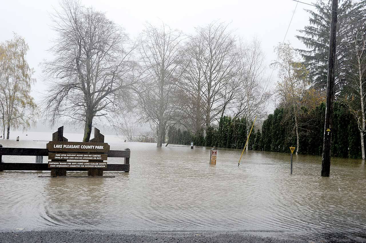 The waters of Lake Pleasant flooded the Lake Pleasant County Park on Monday. The water runs over the West Lake Pleasant Road and into neighboring homes. (Lonnie Archibald/for Peninsula Daily News)