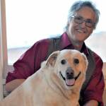 Author Ward Serrill and his dog Dolly Parton, 7, share a moment at the Starlight Room, where Serrill will give readings of  his new memoir, "To Crack the World Open: Solitude, Alaska and a Dog Named Woody." Diane Urbani de la Paz/Peninsula Daily News