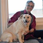 Author Ward Serrill and his dog Dolly Parton, 7, share a moment at the Starlight Room, where Serrill will give readings of his new memoir, To Crack the World Open: Solitude, Alaska and a Dog Named Woody. (Diane Urbani de la Paz/Peninsula Daily News)