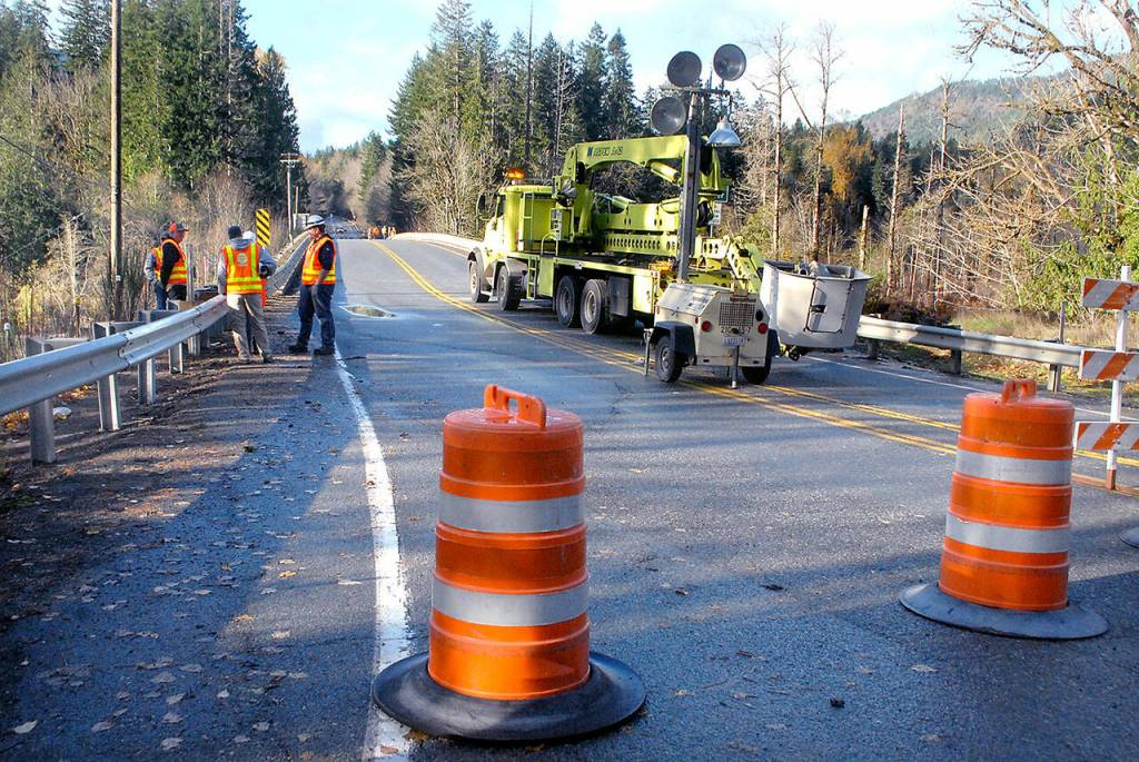 Keith Thorpe/Peninsula Daily News
Washington State Department of Transportation workers stage at the U.S. Highway 101 bridge over the Elwha River west of Port Angeles on Tuesday, waiting for river levels to recede before performing an inspection of the bridge supports.