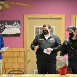Bob Bindschadler of the Quilcene-Brinnon Garden Club, standing at left, and club president Ruth Dunham, seated, presented a $500 check to Brinnon Fire & Rescue chief Tim Manly, second from right, and Quilcene Fire & Rescue Lt. Nick Singleton last Thursday. Manly will use the funding to buy Guardian Angel LED safety lights for rural first responders to wear. (Diane Urbani de la Paz/Peninsula Daily News)
