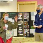 Leslie Tippens of the Quilcene Food Bank thanks Bob Bindschadler of the Quilcene-Brinnon Garden Club for a $950 grant to help the food pantry during the coming year. Seated at left is Cody Maxwell of Center Valley Animal Rescue, which received a $500 grant. (Diane Urbani de la Paz/Peninsula Daily News)