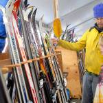 Ned Hammar of Port Angeles and his son, Felix Lubinski Hammar, 9, examine a rack of snow skies during Saturdays Winterfest ski swap in the Black Ball Ferry parking lot on the Port Angeles waterfront. The event, a fundraiser for the Hurricane Ridge Winter Sports Club, featured a variety of skis, snowboards and related sports gear. No total from the event was available on Sunday. (Keith Thorpe/Peninsula Daily News)