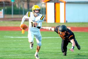 Eric Trent/The Chronicle
Forks quarterback Logan Olson avoids the rush against Napavine in the state 2B quarterfinal Saturday.