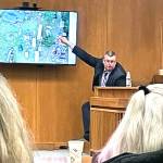 State Patrol Detective Michael Welander displays drone photographs from a triple-murder investigation from Jan. 1, 2019. (Rob Ollikainen/for Peninsula Daily News)