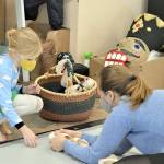 Port Townsend Ballet teacher Krystal Kennedy shows student Soleil Robinson, 6, her toe shoes after class Tuesday afternoon. In the PTBs The Nutcracker next week, Kennedy will dance the roles of the Snow Queen and Dew Drop Fairy. (Diane Urbani de la Paz/Peninsula Daily News)