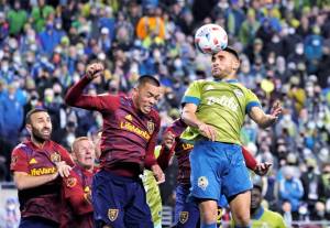 Seattle Sounders' Cristian Roldan, right, heads the ball on a corner kick against Real Salt Lake during the second half of an MLS first-round playoff soccer match Tuesday, Nov. 23, 2021, in Seattle. (AP Photo/Ted S. Warren)