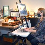 Port Angeles artist Sarah Tucker takes an inventory of items made by area artisans that will be available for sale at the Wintertide Makers Market at the Port Angeles Fine Arts Center. (Keith Thorpe/Peninsula Daily News)