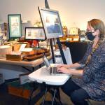 Port Angeles artist Sarah Tucker takes an inventory of items made by area artisans that will be available for sale at the Wintertide Makers Market at the Port Angeles Fine Arts Center. (Keith Thorpe/Peninsula Daily News)