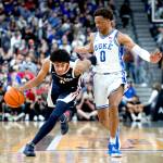 Gonzaga guard Julian Strawther, left, brings the ball up next to Duke forward Wendell Moore Jr. (0) during the first half of an NCAA college basketball game Friday in Las Vegas. (AP Photo/Ellen Schmidt)