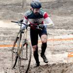 Keith Thorpe/Peninsula Daily News
Bryan Smith of Seattle pushes his bicycle up a steep, muddy hill during Saturday's PNW Extreme Cyclocross mens single-speed race at Extreme Sports Park in Port Angeles.