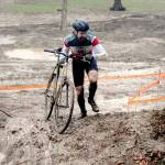 Bryan Smith of Seattle pushes his bicycle up a steep, muddy hill during Saturdays PNW Extreme Cyclocross mens single-speed race at Extreme Sports Park in Port Angeles. (Keith Thorpe/Peninsula Daily News)