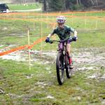 Eleanor Jones of Sequim races through a muddy bog on Saturday at Extreme Sports Park in Port Angeles. (Keith Thorpe/Peninsula Daily News)