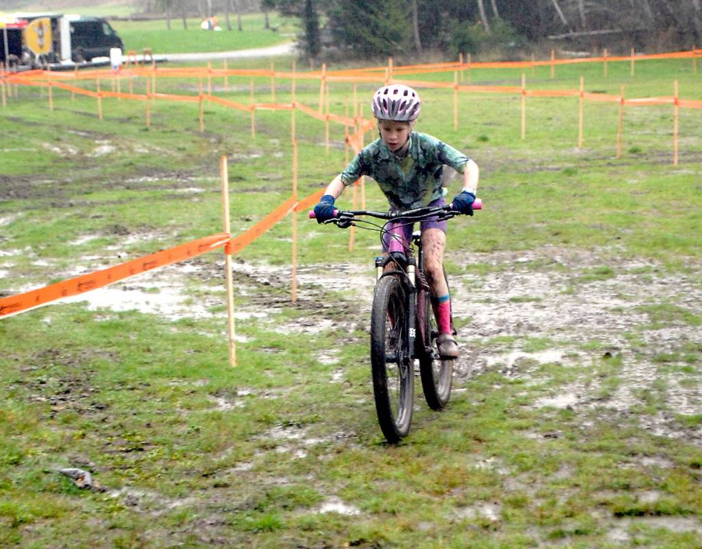 Eleanor Jones of Sequim races through a muddy bog on Saturday at Extreme Sports Park in Port Angeles. (Keith Thorpe/Peninsula Daily News)