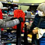 Volunteers A.J. Laverty, left, and Marsha Hamacher organize the winter outfits at the Community United Methodist Churchs clothing room. The room is open for free shopping on Saturdays. (Diane Urbani de la Paz/Peninsula Daily News)