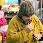 Artist Lisa Leporati checks the fragrance of her flower confetti, one of the items shell offer during the Handwork Market, an artists showcase at the Cotton Building in downtown Port Townsend on Saturday. (Diane Urbani de la Paz/Peninsula Daily News)