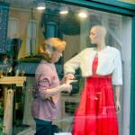 Marion Castaneda prepares a mannequin at her Deja Vu store on Water Street in Port Townsend, where the Main Street Program is organizing a variety of activities this month, including the Winter Window Wander of decorated shop windows downtown and the community Christmas tree lighting at dusk Saturday. Under and near the Tyler Street Plaza tent at Tyler and Water streets Saturday afternoon, the Wild Rose Chorale will sing, Santa will pose for photos and the Kiwanis Choo Choo train will come by. Details are found at the Port Townsend Main Street website. (Diane Urbani de la Paz/Peninsula Daily News)