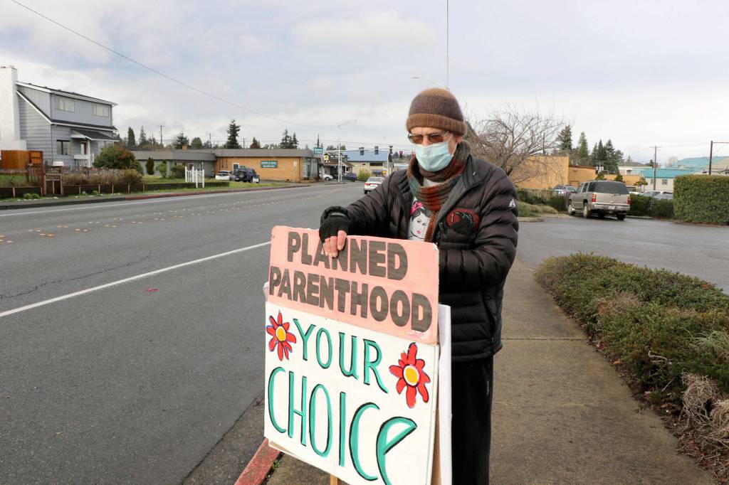 Brian Hogan stands outside the Planned Parenthood Health Center in Port Angeles on Wednesday. (Ken Park/Peninsula Daily News)