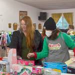 Volunteer Kirsti Turella helps Desirae Cortez look for just the right toy for her children in 2020 at Toys for Sequim Kids in December 2020. The Sequim Community Aid sponsored event takes place Dec. 15 at Sequim Prairie Grange. (Matthew Nash/Olympic Peninsula News Group)