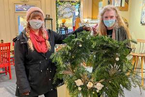 Port Townsend Main Street Program

 Eryn Smith, on left, presents a gold award to JoAnn Williams for the window at Earthenworks Gallery.