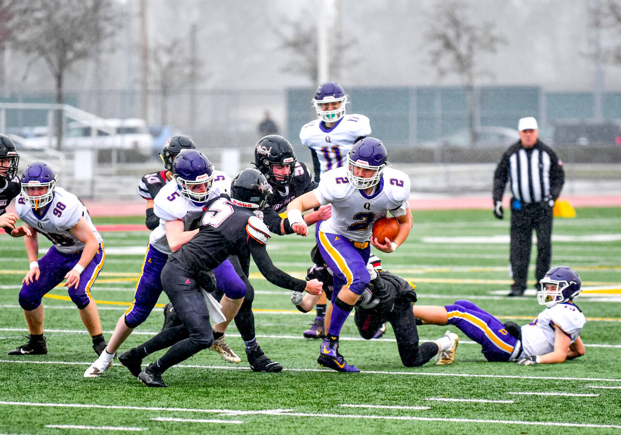 Jim Wilkerson/for Peninsula Daily News Quilcenes Bishop Budnek runs the ball against Almira-Coulee-Hartline in the 1B state football championship at Mount Tahoma High School on Saturday. ACH won 50-20. Also in on the play are Quilcenes Maxx Budnek (98), Dominic Smith (5) and Nathan Kieffer (11).