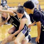 Lonnie Archibald/for Peninsula Daily News
Sequim's Sammie Bacon, left, and Forks' Keiri Johnson battle in the key while Sequim's Bobbie Mixon, right, looks on. The Sequim girls won 61-44.