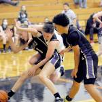 Lonnie Archibald/for Peninsula Daily News Sequims Sammie Bacon, left, and Forks Keiri Johnson battle in the key while Sequims Bobbie Mixon, right, looks on. The Sequim girls won 61-44.