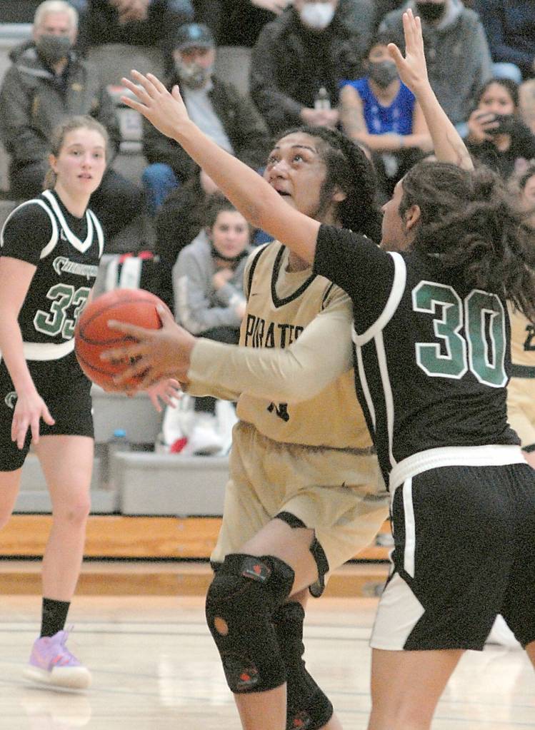 Keith Thorpe/Peninsula Daily News
Peninsula's Ituau Tuisaula, center, heads for the lane as Chemeketa's Mari-Ann Martinez, right, tries to hinder her progress on Saturday in Port Angeles.