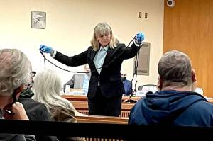 Clallam County Sheriffs Detective Stacy Sampson displays a rope found in the master bedroom at 52 Bear Meadow Road during Dennis Marvin Bauers triple0murder trial in Clallam County Superior Court on Monday. (Rob Ollikainen/for Peninsula Daily News)