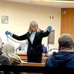 Clallam County Sheriffs Detective Stacy Sampson displays a rope found in the master bedroom at 52 Bear Meadow Road during Dennis Marvin Bauers triple0murder trial in Clallam County Superior Court on Monday. (Rob Ollikainen/for Peninsula Daily News)