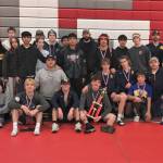 Courtesy of Forks High School
The Forks boys and girls wrestling teams celebrate their second- and fourth-place trophies at the Tony Saldiver Invitational held in Granger on Saturday.
