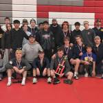 Courtesy of Forks High School The Forks boys and girls wrestling teams celebrate their second- and fourth-place trophies at the Tony Saldiver Invitational held in Granger on Saturday.