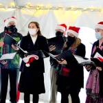 The a cappella Wild Rose Chorale, caroling in downtown Port Townsend earlier this month, will give the first in-person Candlelight Concert in 20 months this Thursday at Trinity United Methodist Church. The members are, from left, director Leslie Lewis, Doug Rodgers, Viola Frank, Al Thompson, Sarah Gustner-Hewitt, Eugenia Frank, Steve Duniho and Lynn Nowak; not pictured is Chuck Helman. (Diane Urbani de la Paz/Peninsula Daily News)