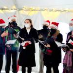 The a cappella Wild Rose Chorale, caroling in downtown Port Townsend earlier this month, will give the first in-person Candlelight Concert in 20 months this Thursday at Trinity United Methodist Church. The members are, from left, director Leslie Lewis, Doug Rodgers, Viola Frank, Al Thompson, Sarah Gustner-Hewitt, Eugenia Frank, Steve Duniho and Lynn Nowak; not pictured is Chuck Helman. (Diane Urbani de la Paz/Peninsula Daily News)