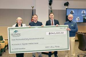 Dave Logan
Holding a giant check of the $540,000 donation from the Olympic Medical Center Foundation to the hospital are, from left, OMC Executive Committee member Karen Rogers, OMC Commissioner Chair John Nutter, OMC CEO Darryl Wolfe, and Bruce Skinner, executive director of the foundation.