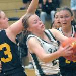 Keith Thorpe/Peninsula Daily News
Port Angeles' Anna Petty, center, pulls down a rebound surrounded by Bainbridge's Macy Kingrey, left, and Grace Colburn, right, on Thursday at Port Angeles High School.