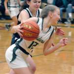 Port Angeles Isabelle Felton, front, spins towards the lane as Bainbridges Caroline Payne on Thursday night in Port Angeles. (Keith Thorpe/Peninsula Daily News)