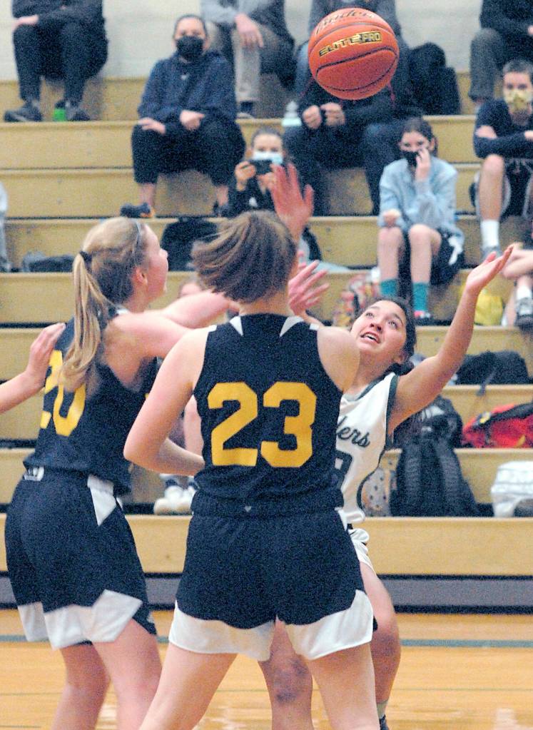 Port Angeles Piper Williams, right, fights for a rebound with Bainbridges Grace Colburn, left, and Macy Kingrey on Thursday in Port Angeles. (Keith Thorpe/Peninsula Daily News)
