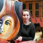 Director Ginny Holladay holds artwork for "Angel Street" that was created and donated by Ryoko Toyama. Photo courtesy of Olympic Theatre Arts