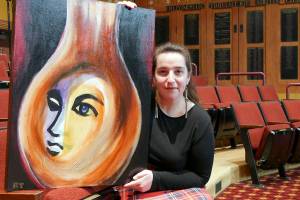 Director Ginny Holladay holds artwork for "Angel Street" that was created and donated by Ryoko Toyama. Photo courtesy of Olympic Theatre Arts