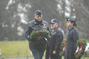 Lt. Col. Susan Sorensen (ret.) prepares to lay a ceremonial wreath honoring those who served in the U.S. Coast Guard. (Michael Dashiell/Olympic Peninsula News Group)