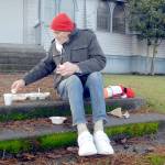 Michael Freestone of Port Angeles sits on the steps in front of the Salvation Army Church in Port Angeles as he enjoys a carry-out Christmas Eve lunch. The organization served dozens of lunches with an outdoor dining twist in its annual holiday tradition. (Keith Thorpe/Peninsula Daily News)