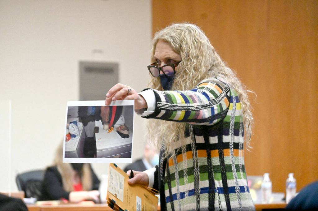 Port Angeles attorney Karen Unger, representing accused triple murderer Dennis Bauer, shows photographic evidence to a jury deciding on Bauers fate. (Paul Gottlieb/Peninsula Daily News)