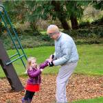 Mark Senffner of Portland, Ore., helps daughter Fionn, 3 ½, with her mittens during a Christmas Eve visit to Chetzemoka Park in Port Townsend. The pleasant but chilly weather on Friday turned colder on Saturday with overnight snow forecast. Diane Urbani de la Paz/Peninsula Daily News
