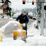 Port Angeles Parks and Recreation Department employee Lukas Cox uses a snowblower to clear a sidewalk at The Gateway at Front and Lincoln streets on Thursday. (Keith Thorpe/Peninsula Daily News)
