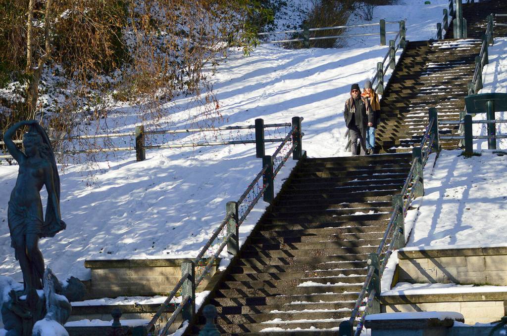 Patrick Jennings and Virginia Grace of Port Townsend descend the Taylor Street steps into downtown Port Townsend on Thursday afternoon. The sun broke through the clouds during the late morning, sending the temperature 1 degree above freezing. (Diane Urbani de la Paz/Peninsula Daily News)