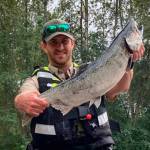 New rafts donated to Washington Department of Fish & Wildlife were used to great effect this summer, fishing advocates say, providing the means to effectively patrol smaller rivers. On a day when a number of citations for violations were written, WDFW officer Patrick Murray holds up a wild chinook an angler had kept after cutting off the adipose fin. (Photo courtesy of WDFW)
